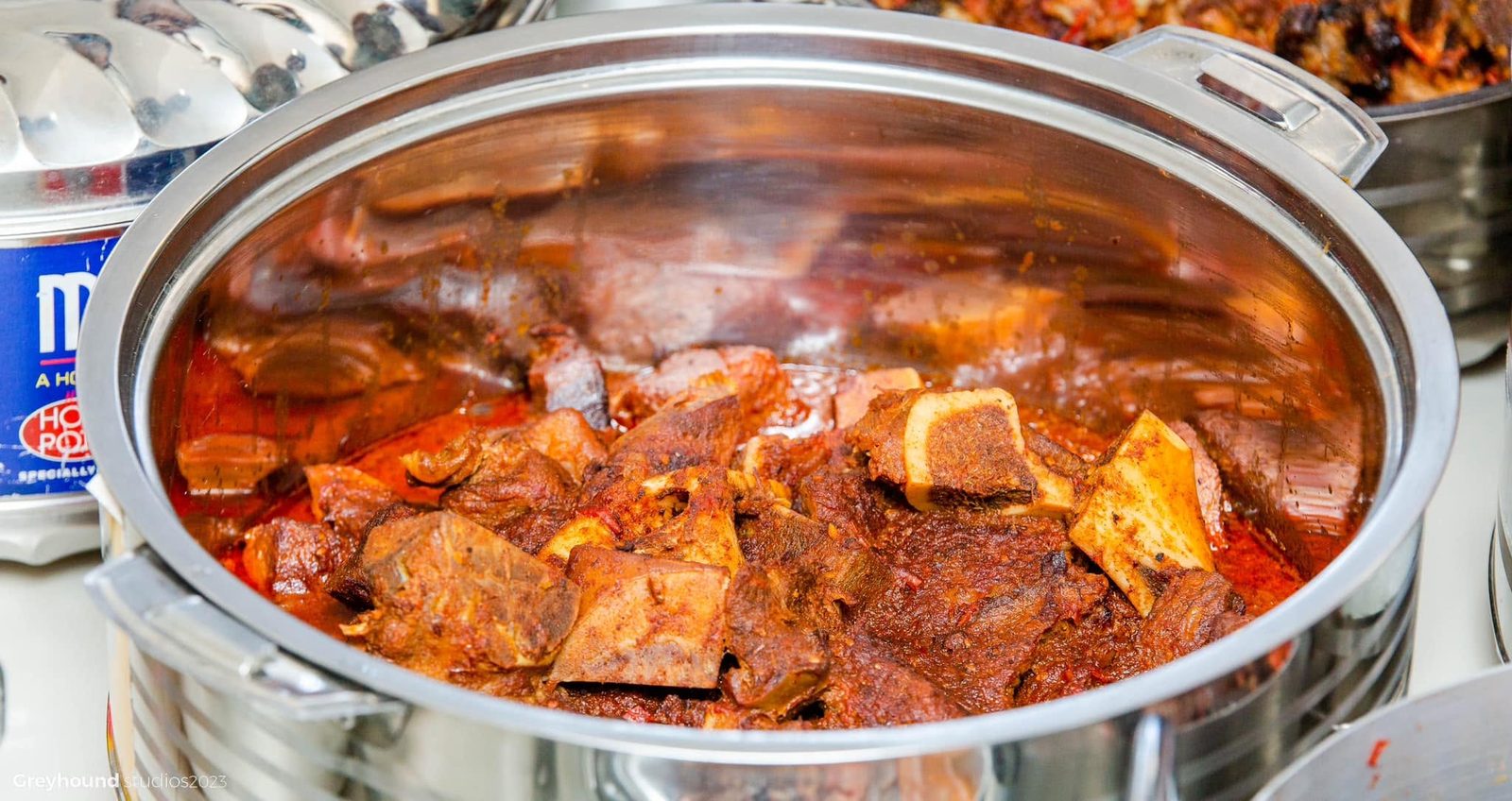 Goat stew in a steel serving tray