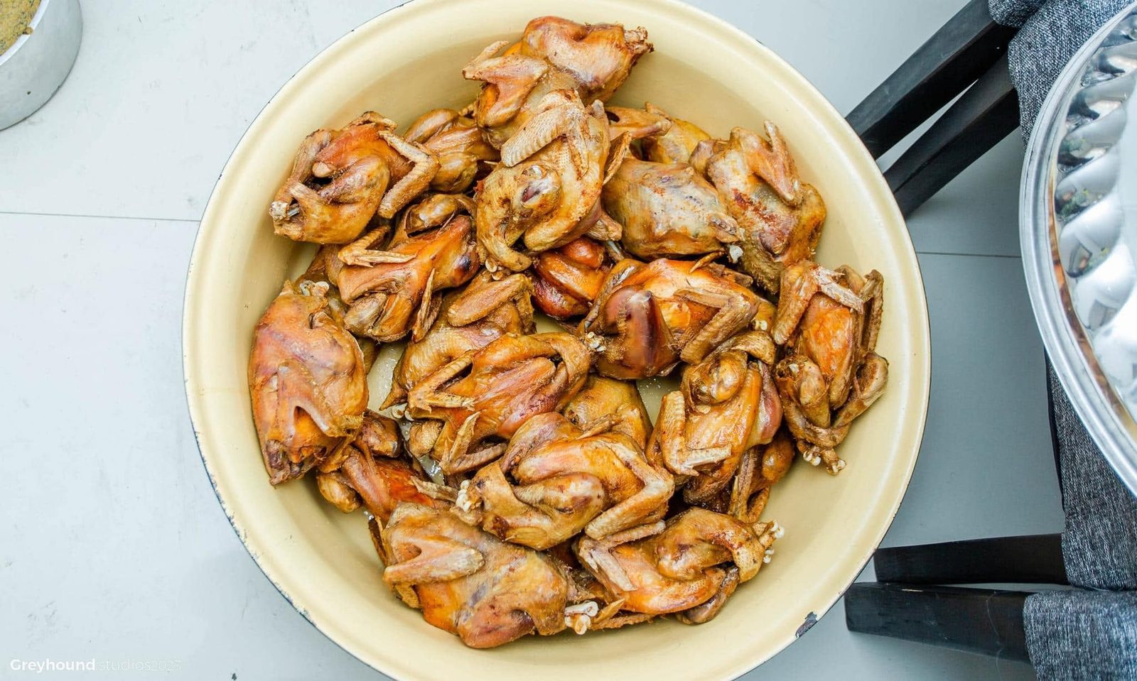 Roasted whole chickens in a bowl