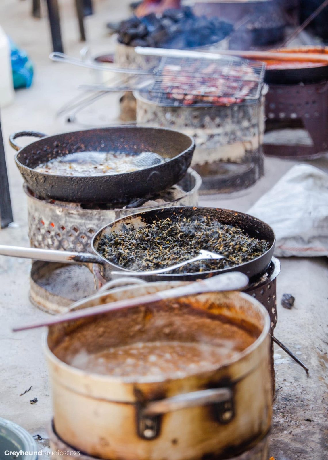 Pots and a grill over open fires