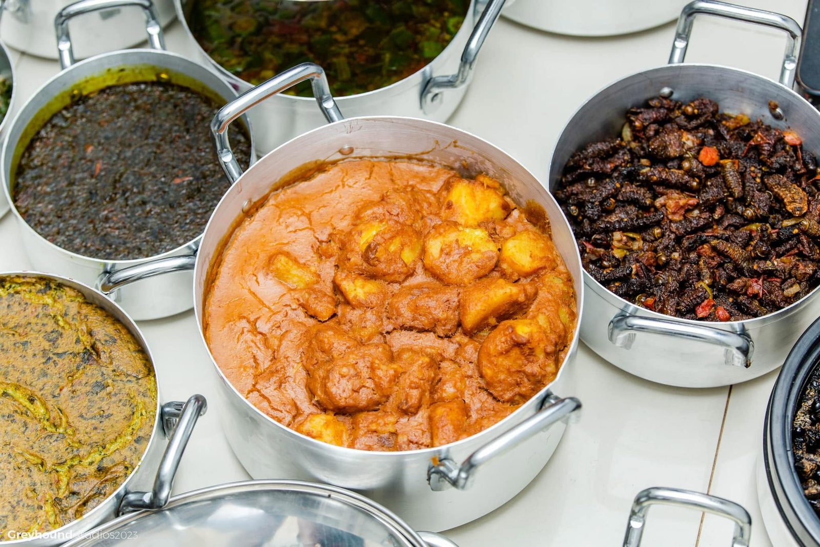 Pots of stew, greens and relishes