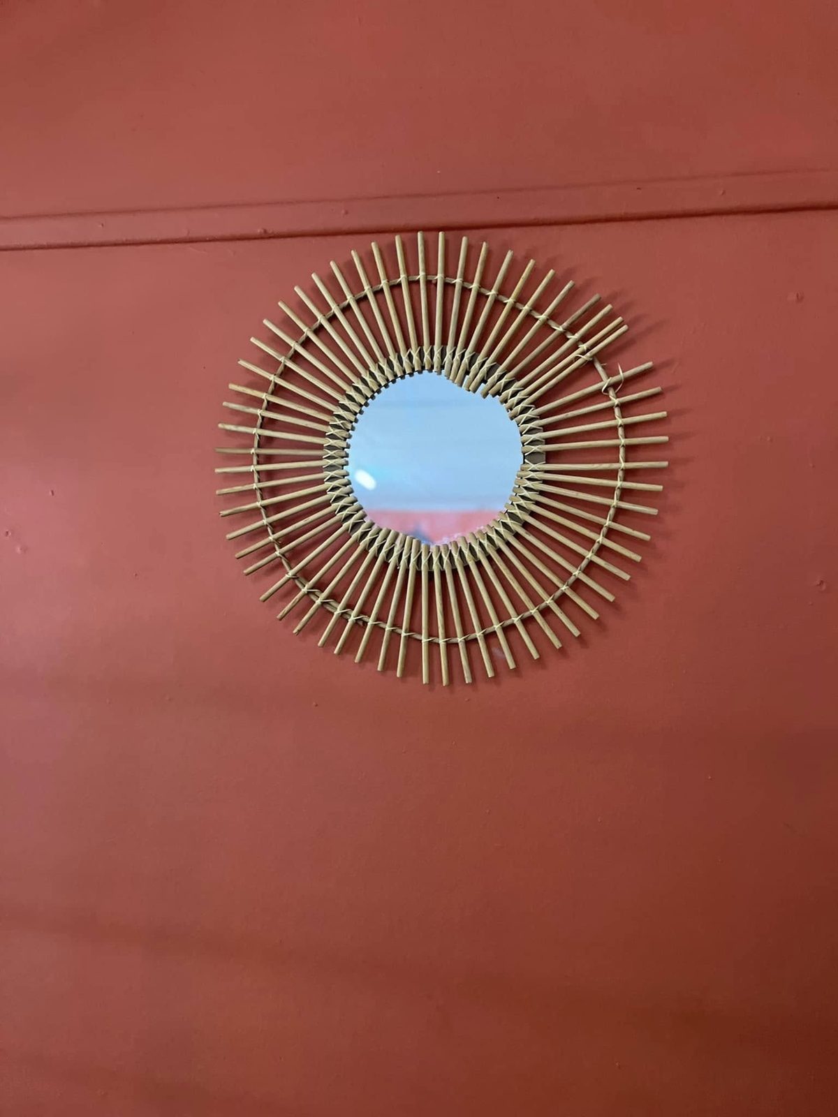 Sunburst mirror on the orange wall